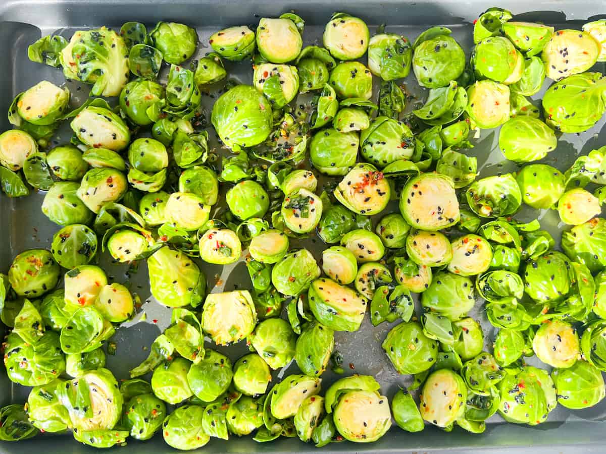 Raw hot honey brussel sprouts on a pan.