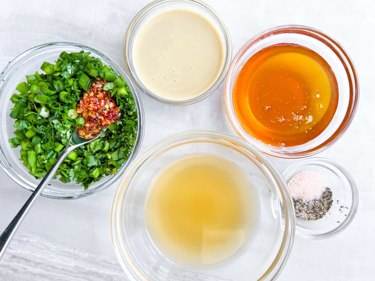 Dressing ingredients in separate bowls.