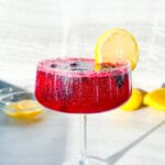 Finished blackberry lemon mocktail garnished with a lemon/