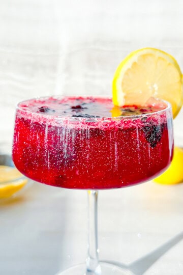 Finished blackberry lemon mocktail garnished with a lemon/