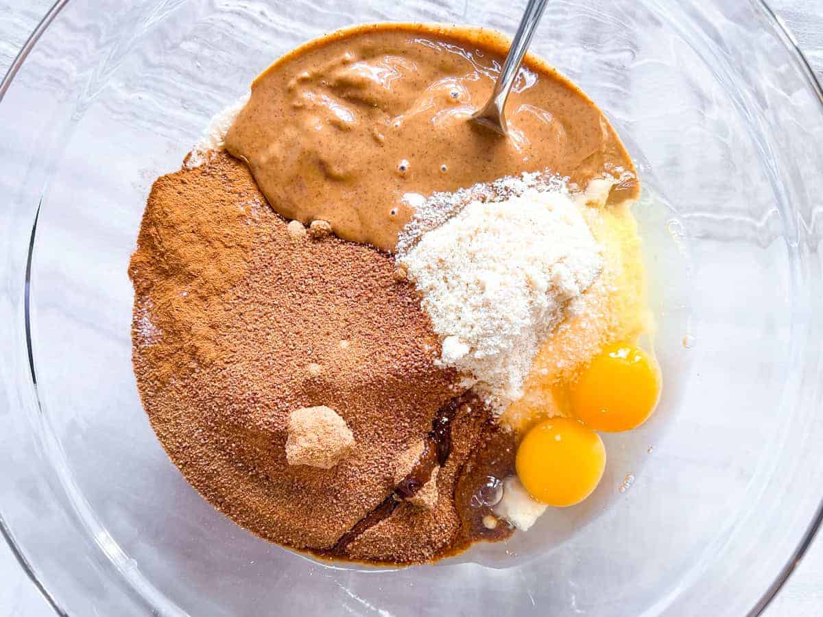 All of the ingredients for the key lime  pie crust in a large clear bowl.