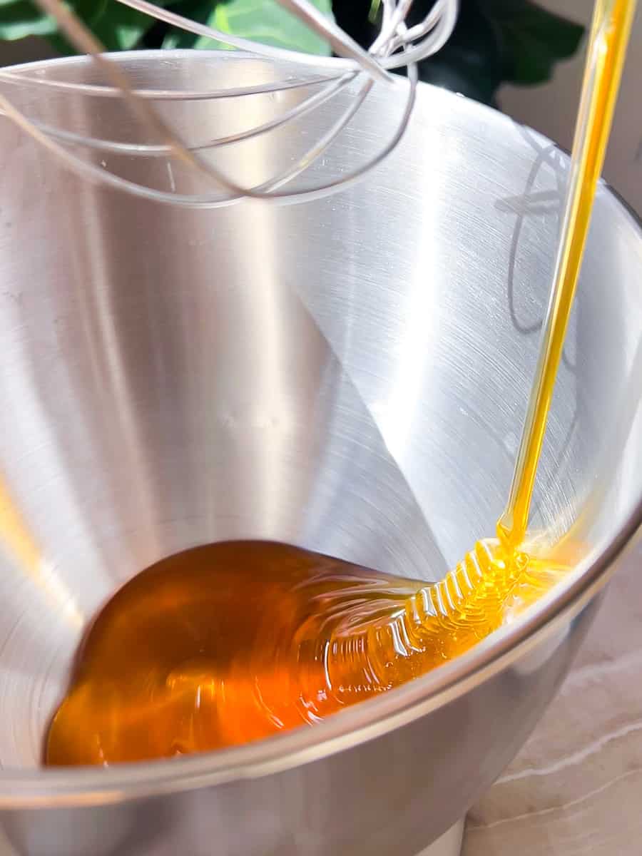 Honey being poured into a stand mixer.