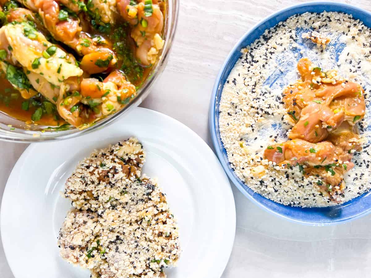 Dredging station set up with breadcrumbs and chicken thighs.