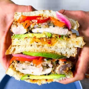 Finished chicken katsu sandwich being held.