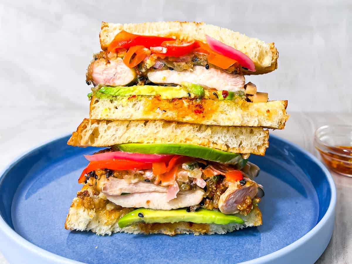 Finished Chicken Katsu sandwich sitting on a blue plate.