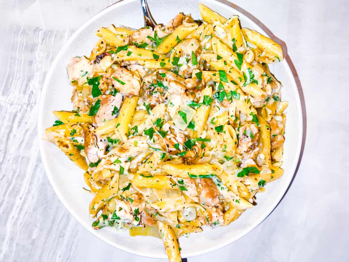 Garlic chicken parmesan pasta in a large white bowl.