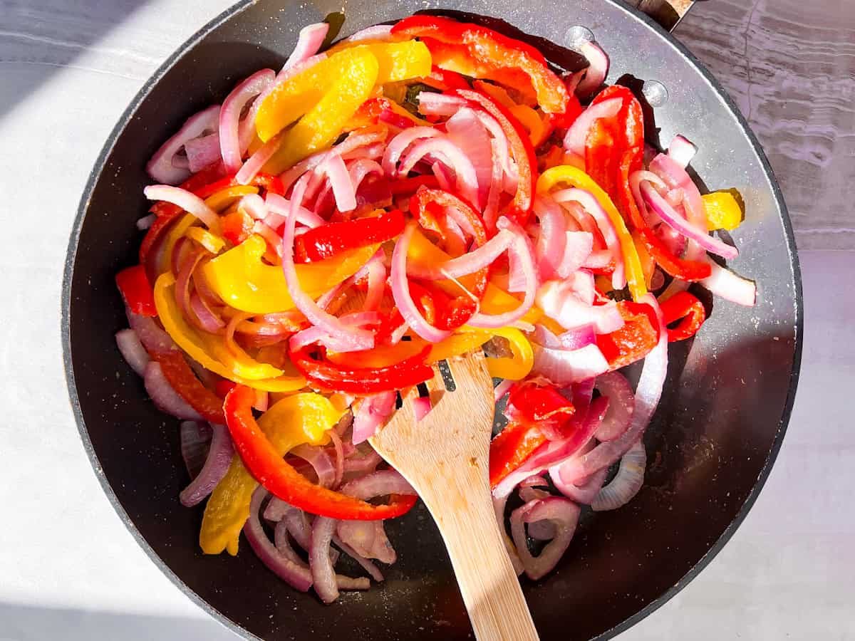 Bell peppers and red onions sauteing.