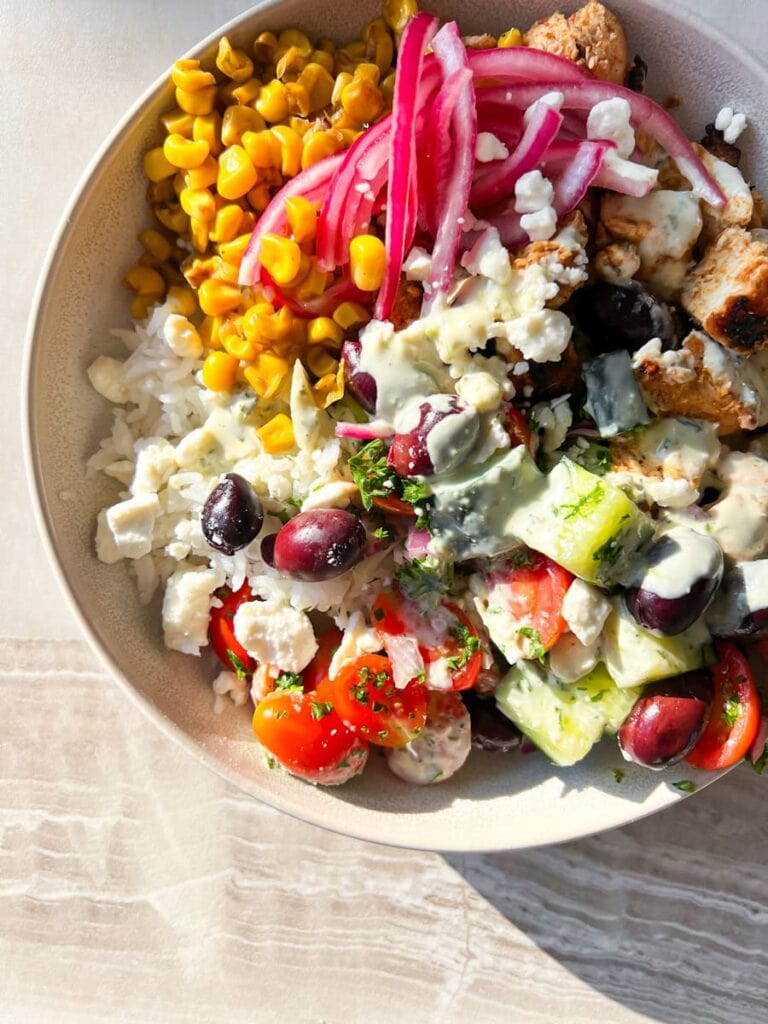 Cava Bowls with harissa honey chicken, corn, cucumber salad, & Dill dressing.