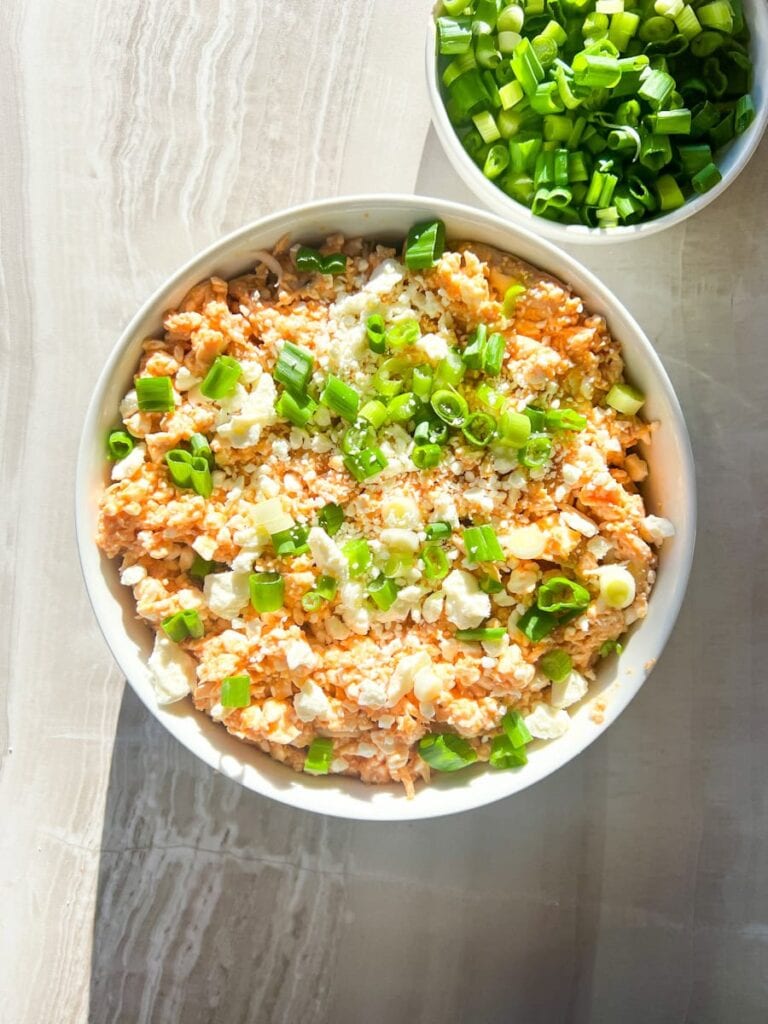 Buffalo dip topped with green onions.