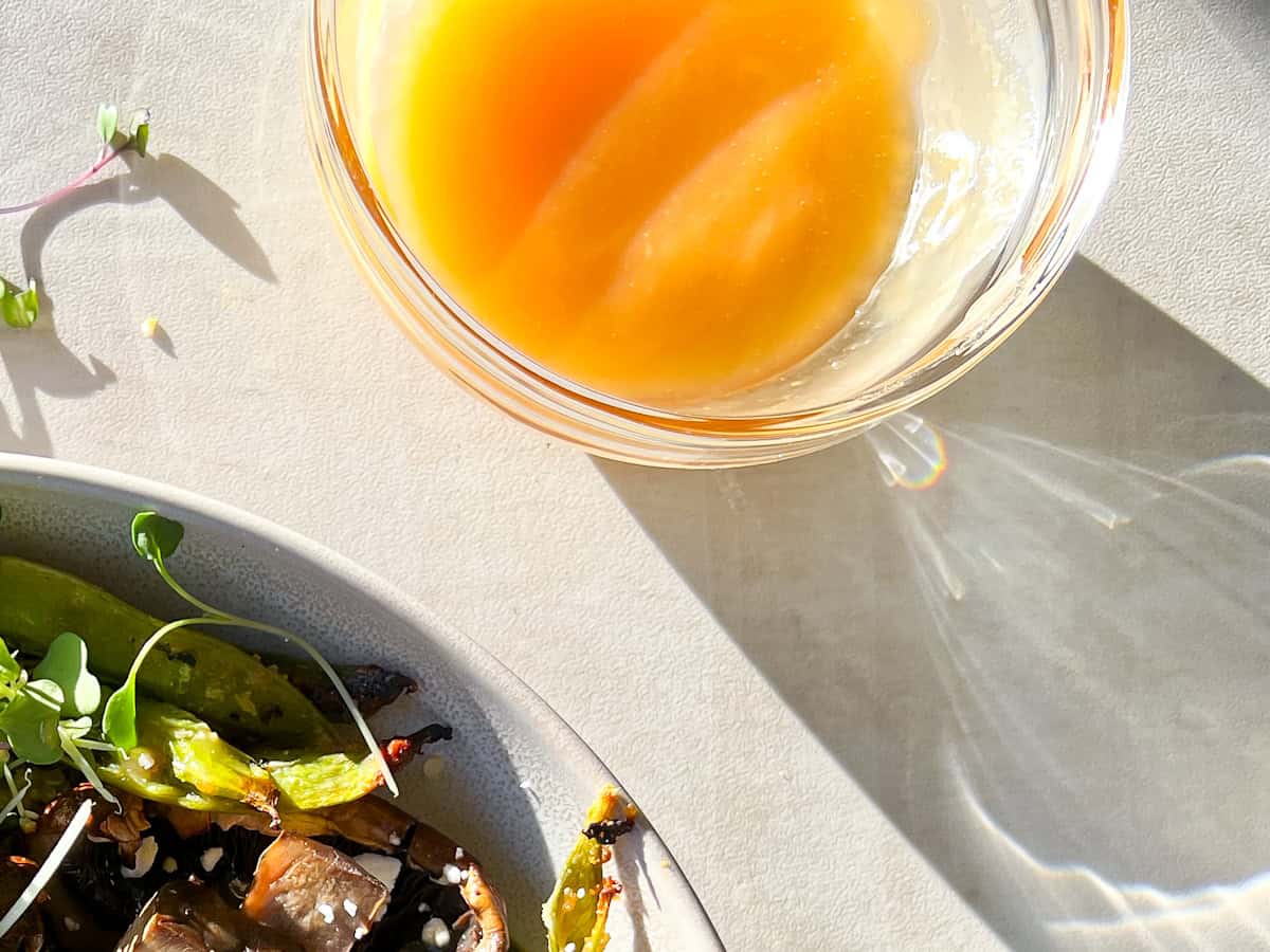 Ancient grain bowl honey miso dressing in a clear bowl.
