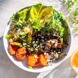 Ancient grain bowls assembled in bright lighting.