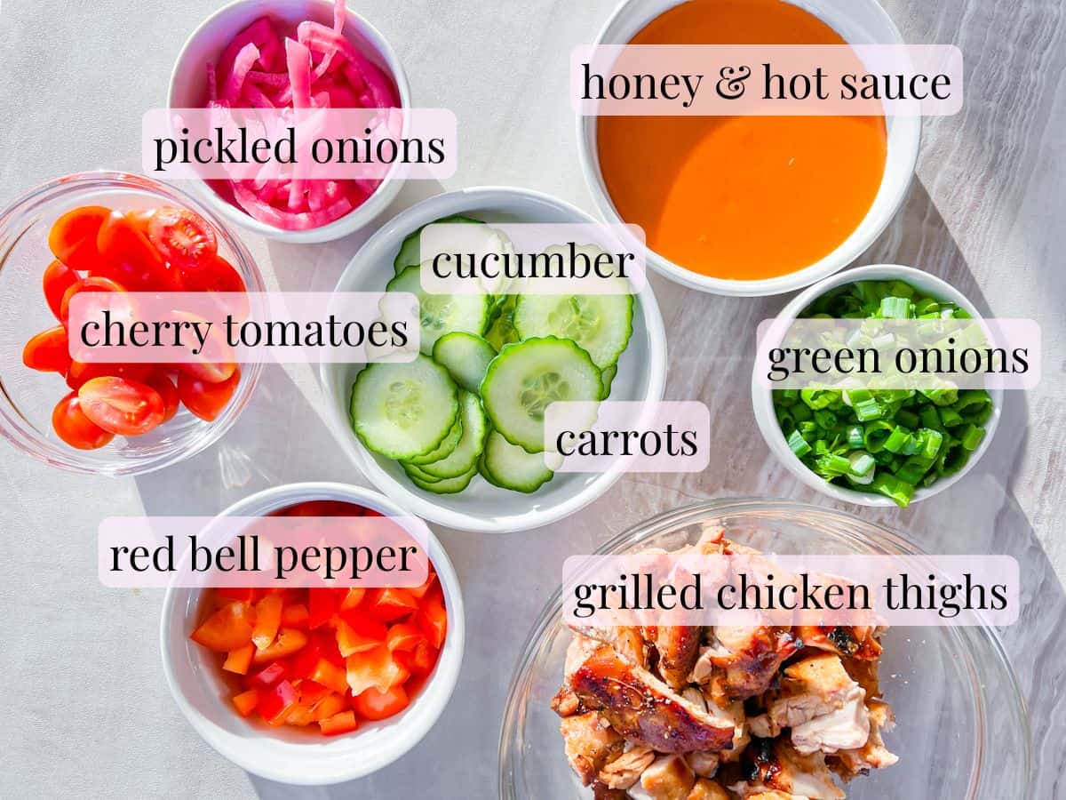 Buffalo chicken bowl ingredients in small bowls and labeled.
