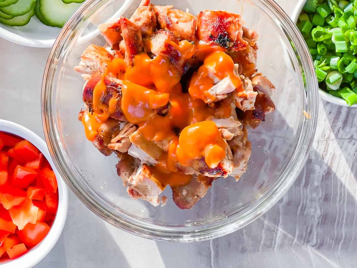 Chicken thighs coated in homemade buffalo sauce.