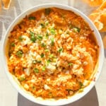 Finished high protein buffalo chicken dip in a white bowl.