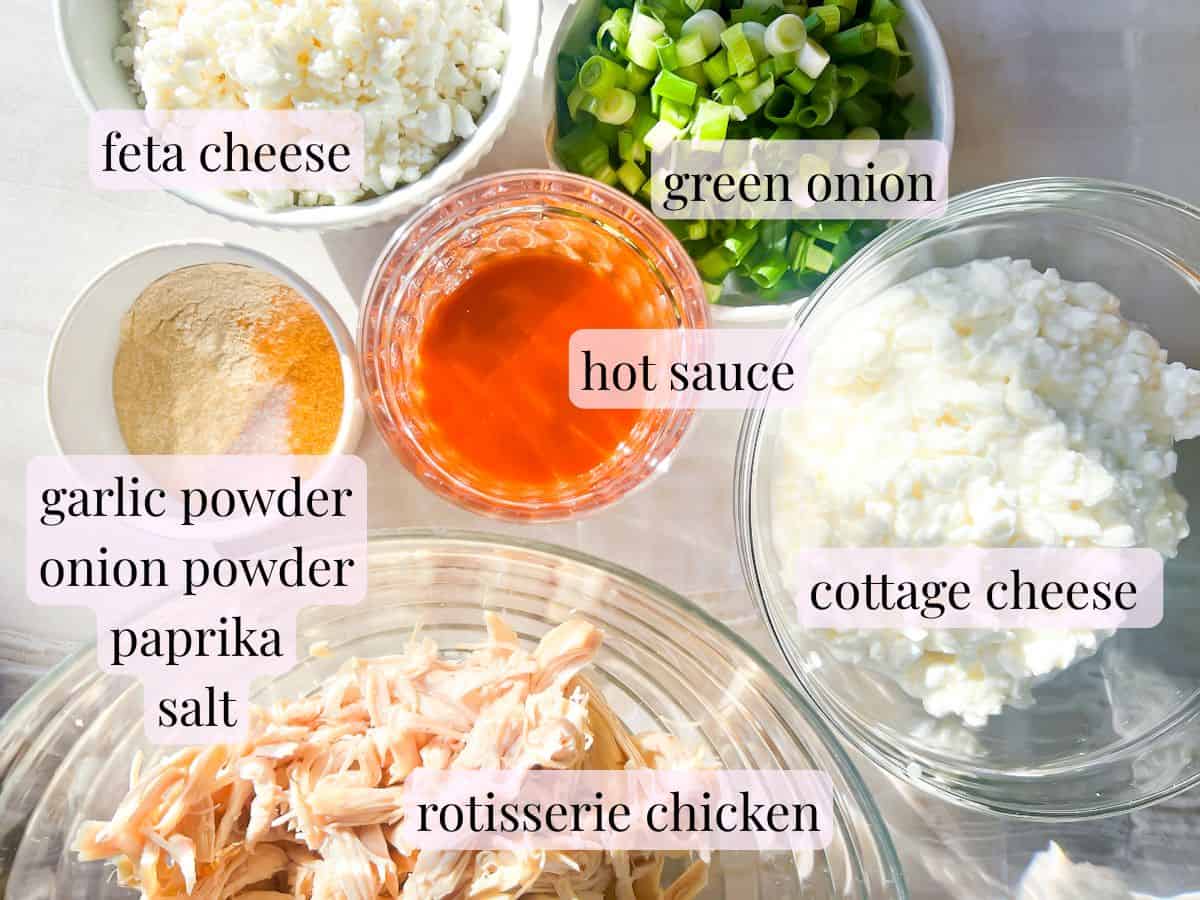 High protein buffalo chicken dip ingredients labeled in bowls.