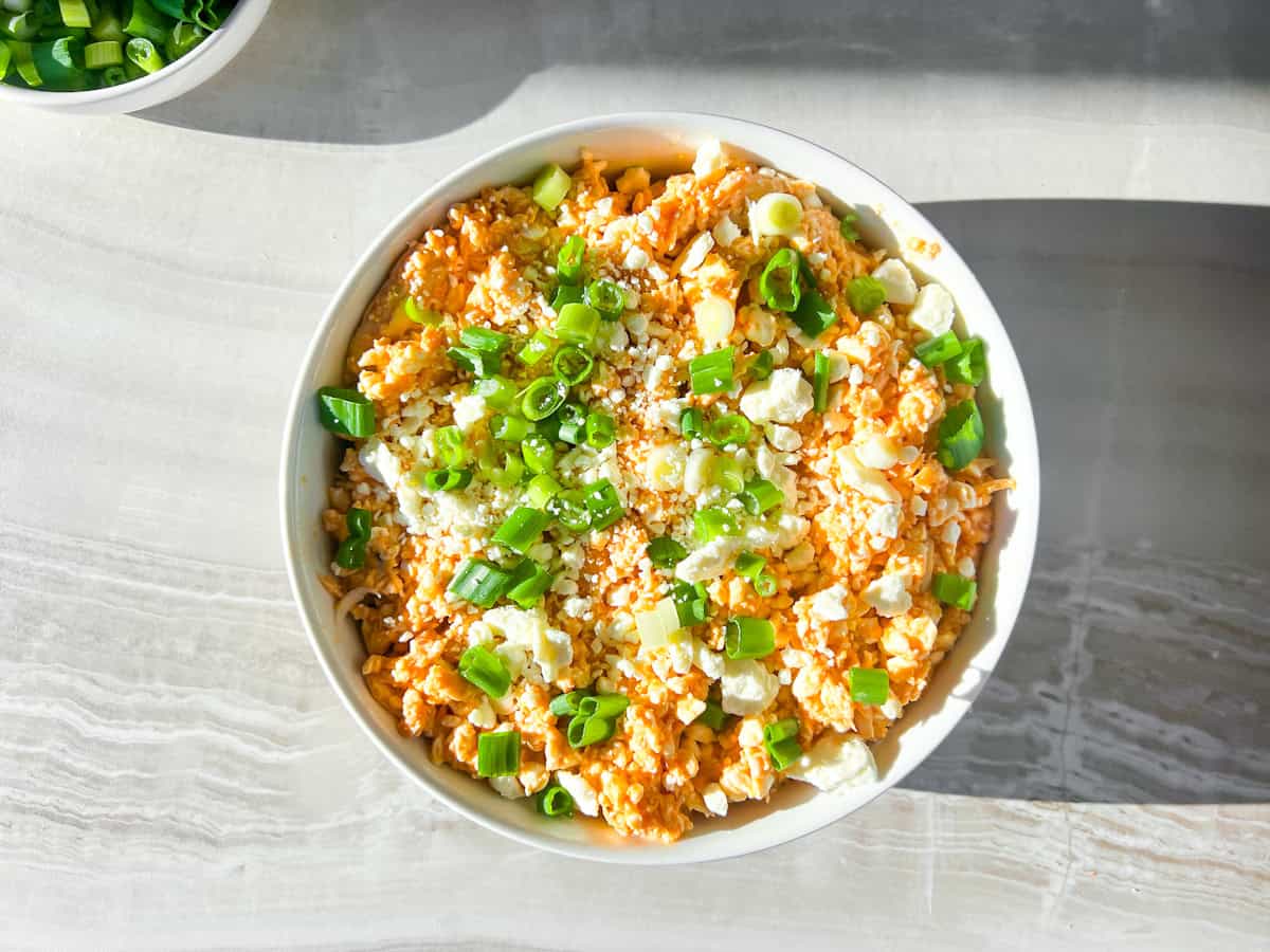 Not yet baked buffalo chicken dip in a bowl.