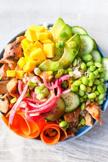 Garnished teriyaki chicken poke bowls.