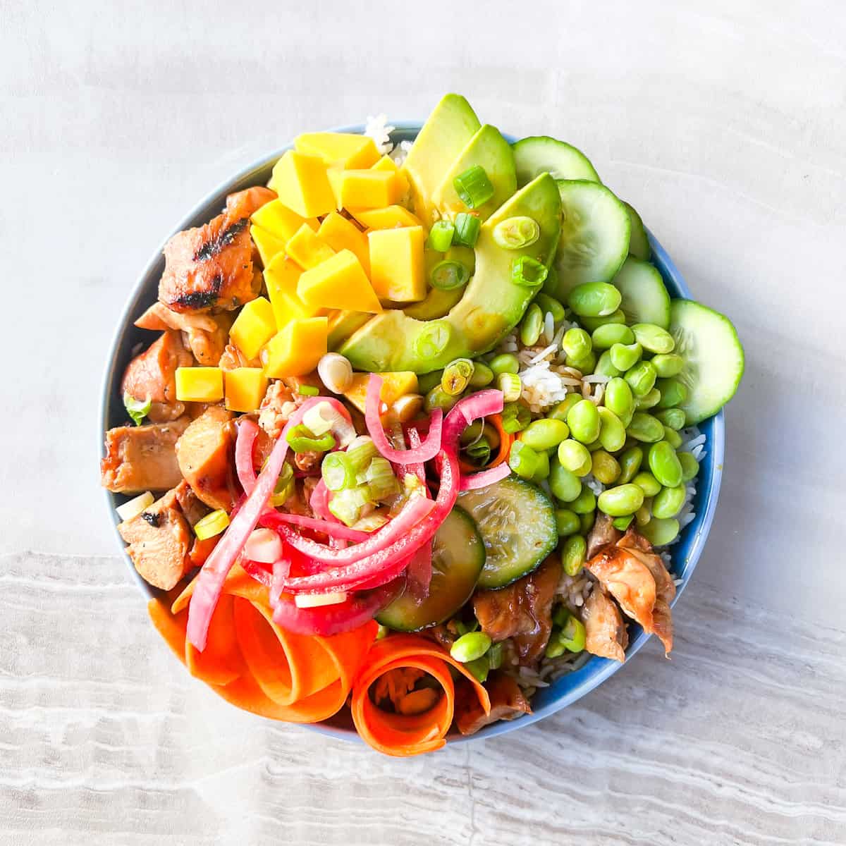 Garnished teriyaki chicken poke bowls.