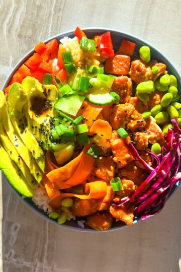 Salmon poke bowl in a blue bowl.