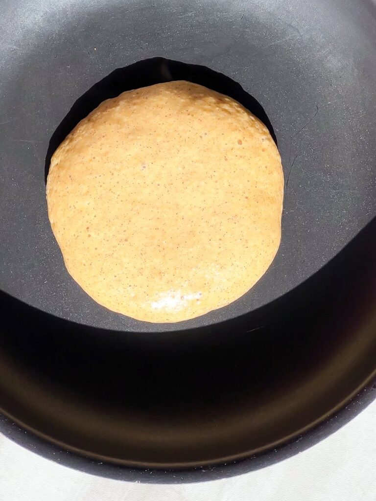 Pancake batter on pan.