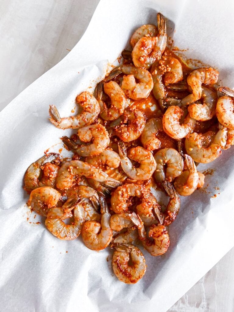 Shrimp seasoned on a pan.