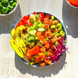 Salmon poke bowl in a blue bowl.