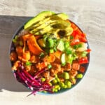 cooked salmon poke bowls in a blue bowl with a title "salmon poke bowls".