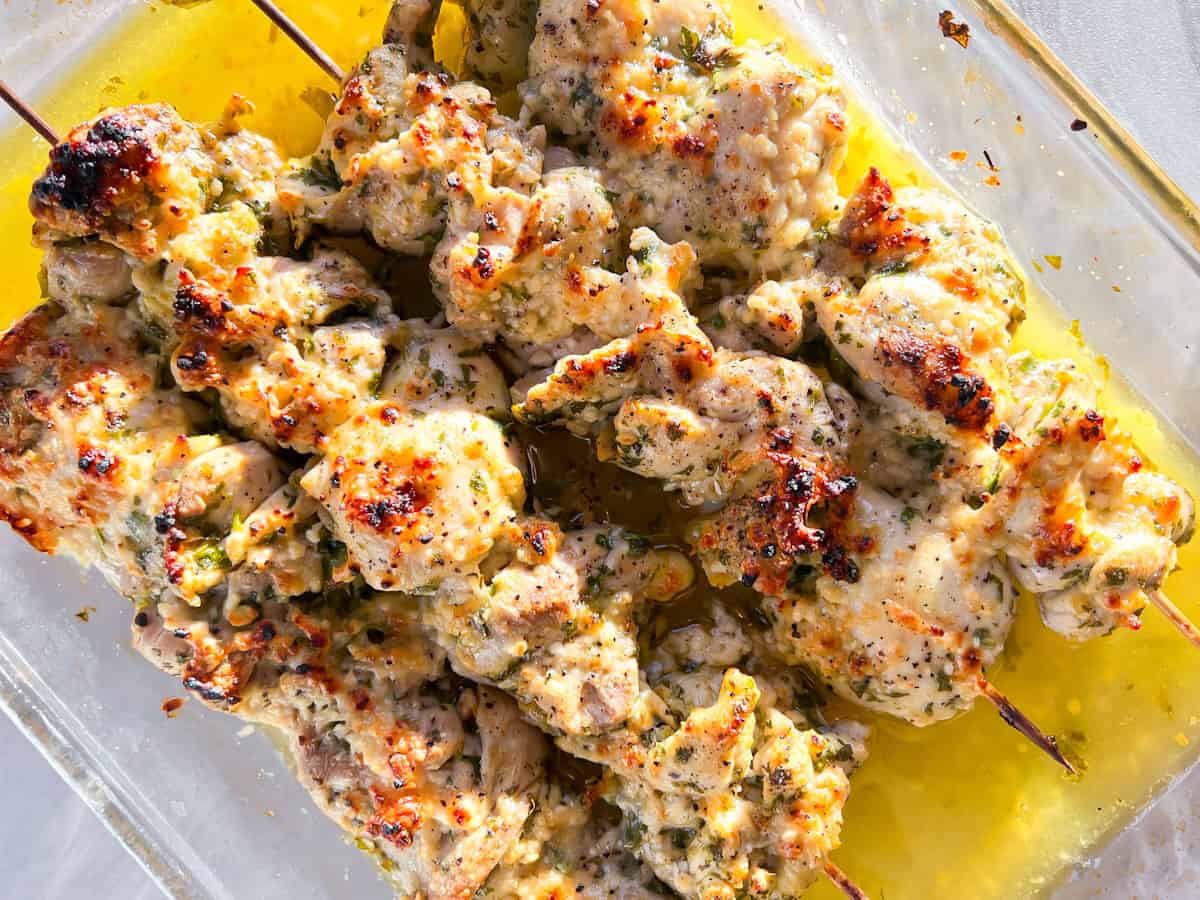 Fully baked garlic parmesan chicken skewers.