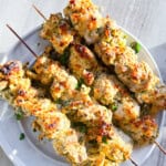 Garlic Parmesan Chicken Skewers on a white plate.