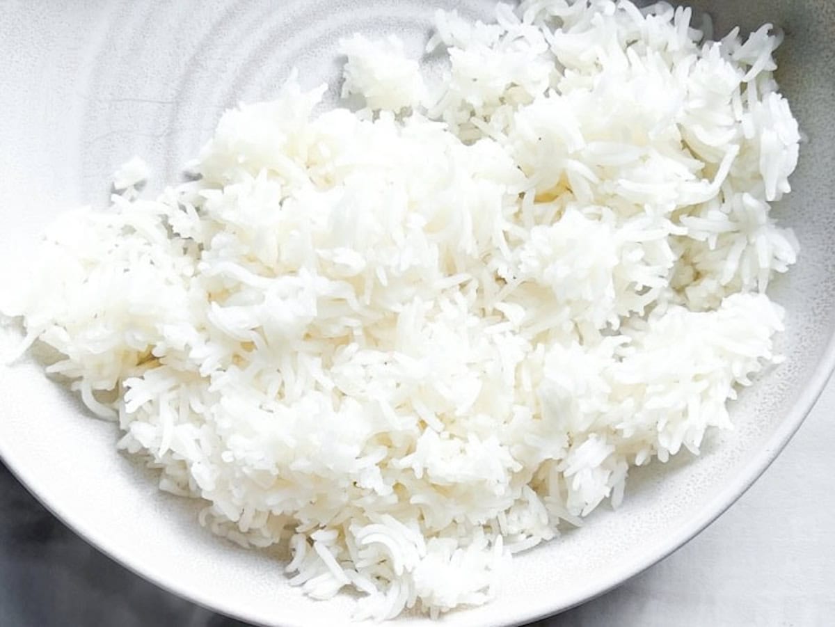 Cooked rice in a white bowl.