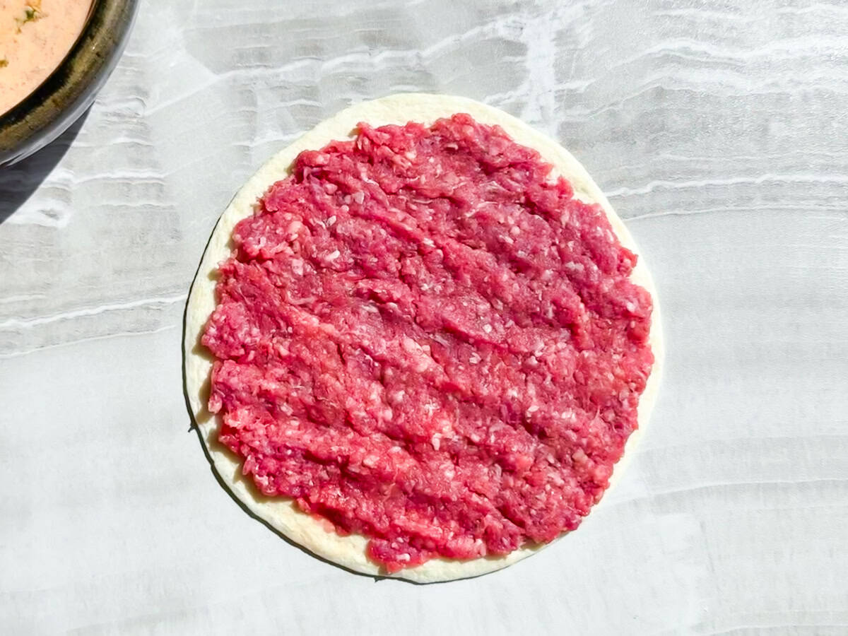 Lean ground beef pressed onto almond flour tortilla.