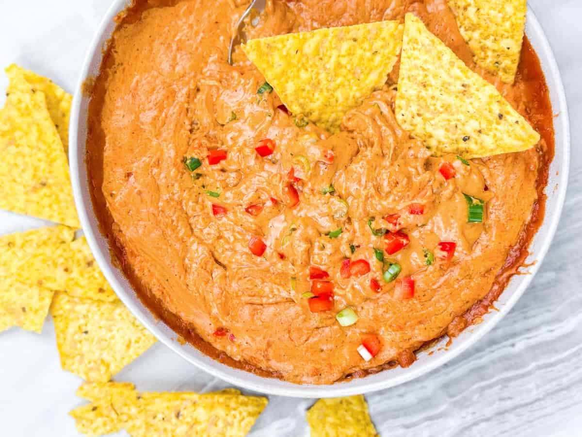 Cottage cheese queso with a chip dipped in the queso.