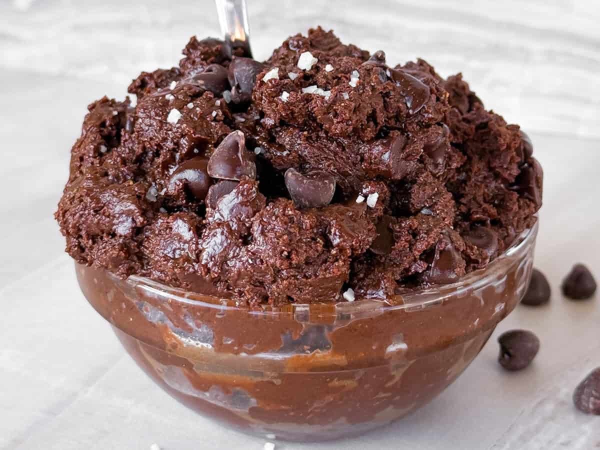 Finished edible brownie batter in a bowl with salt on top.