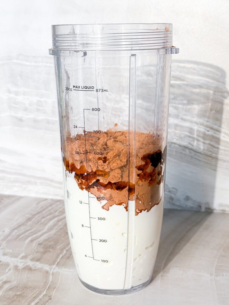 Blender cup with all of the ingredients.