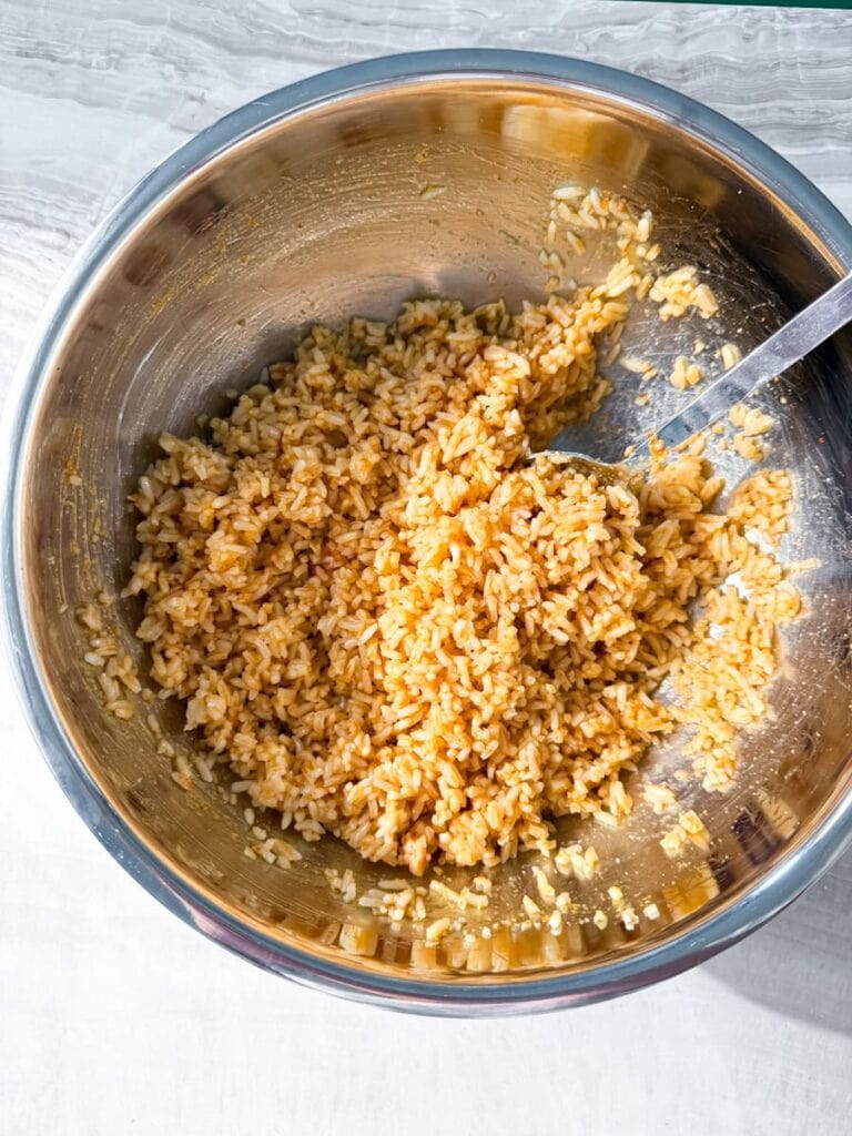 Stirring in crispy rice ingredients.