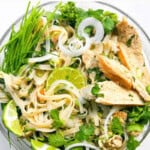 Asian Chicken Noodle Soup in a clear bowl.