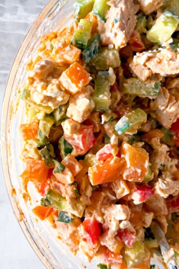 Buffalo chicken salad in a clear bowl.