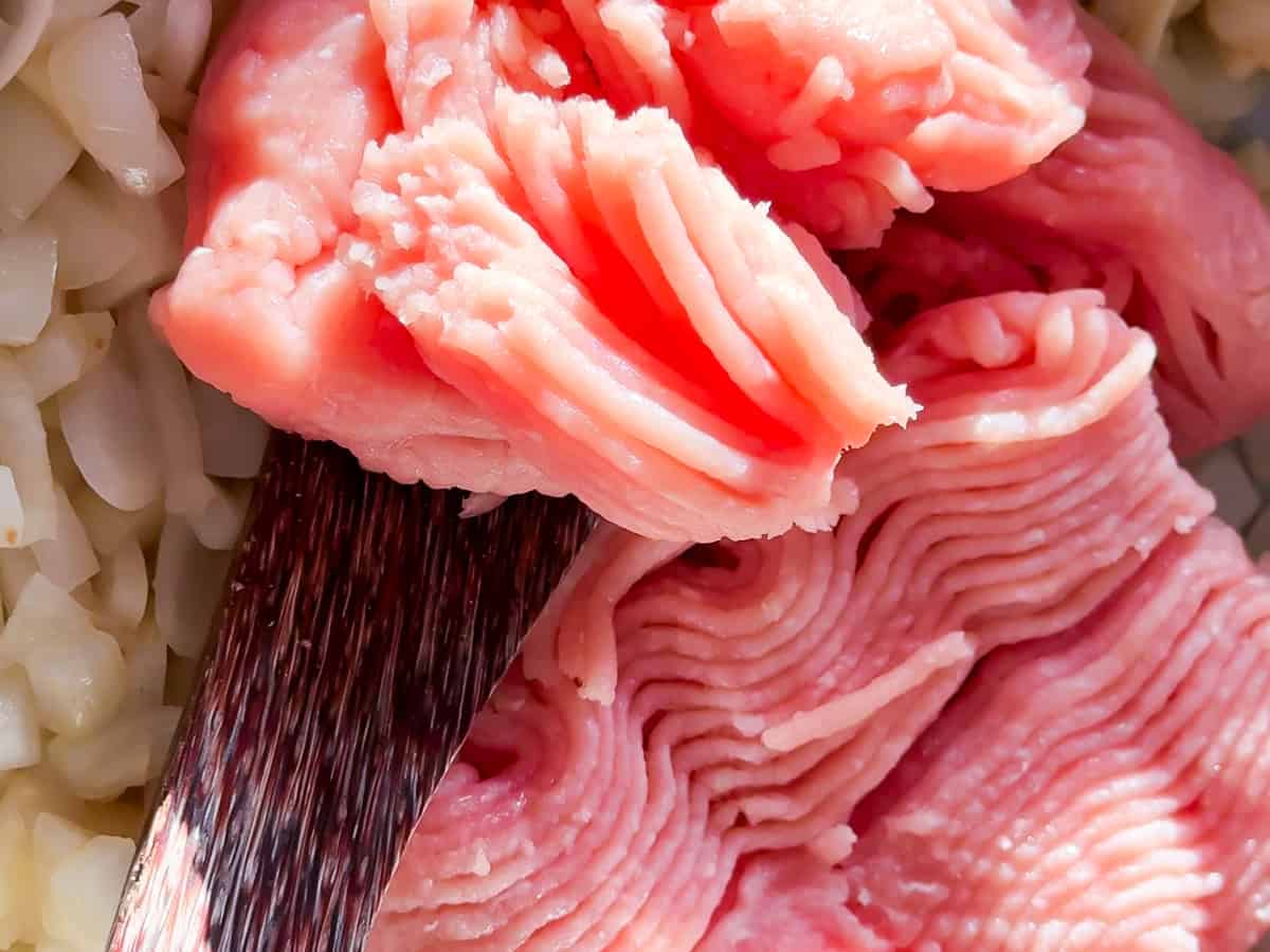 Ground chicken with onions in the pan.