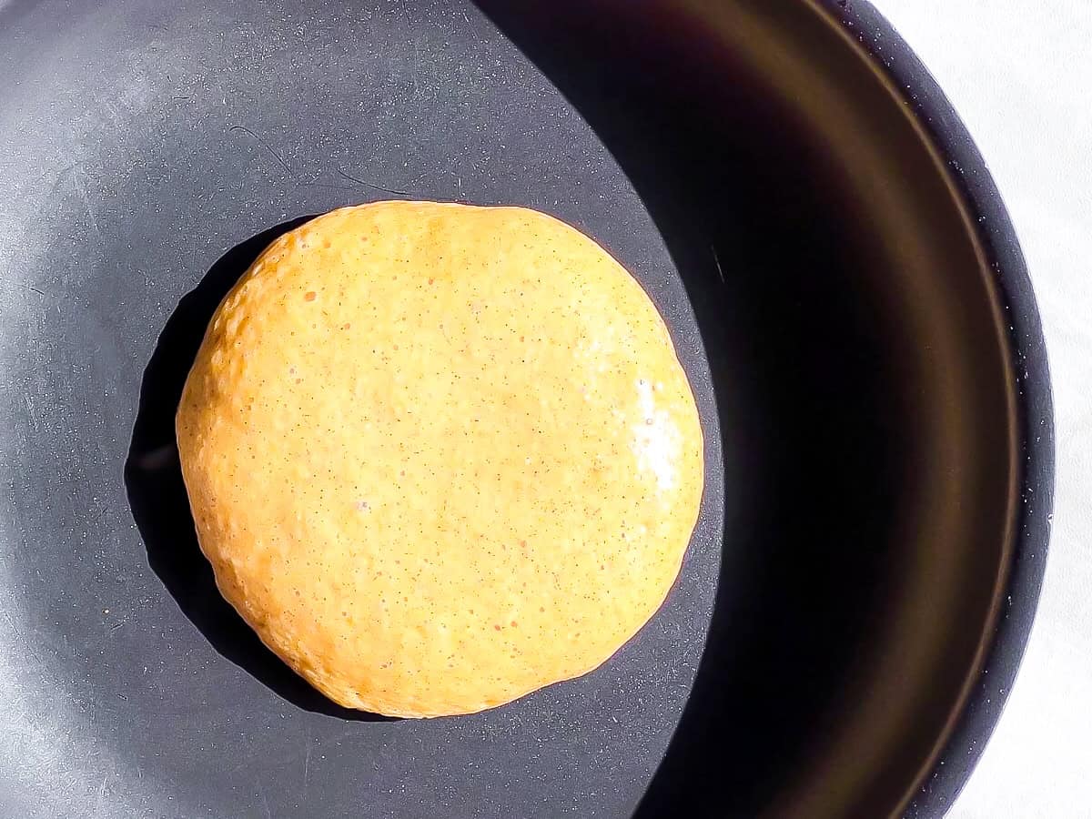 Pancake cooking in a skillet.