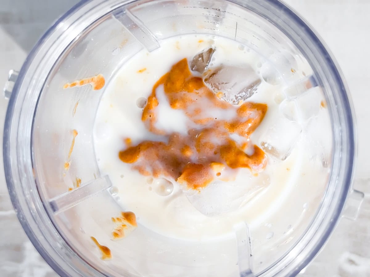 All of the smoothie ingredients in the blender.