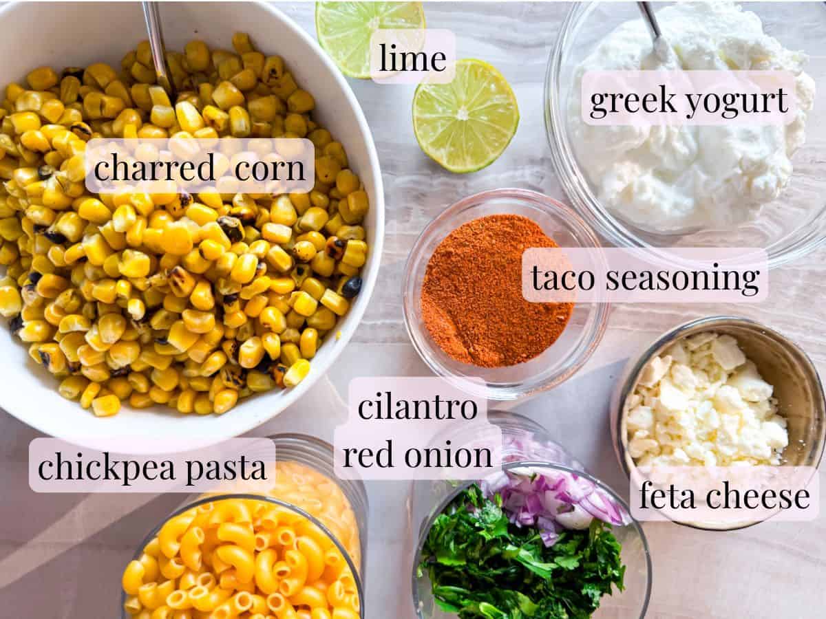 Elote pasta salad ingredients in bowls.