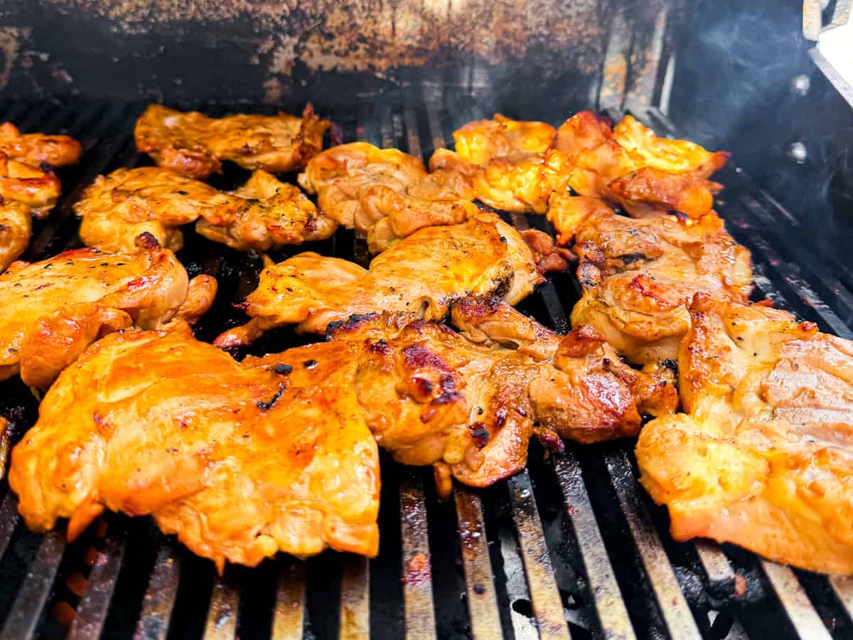 Grilled chicken thighs on the grill.