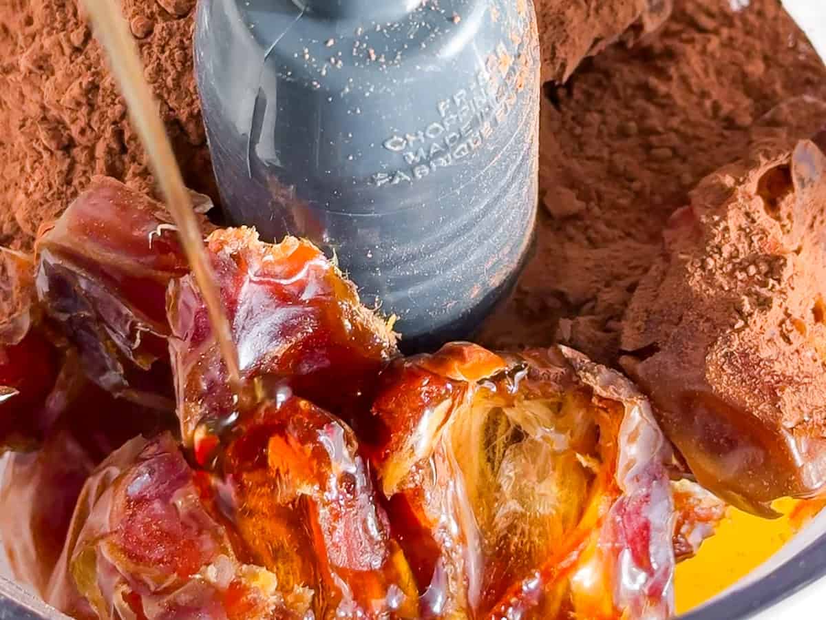Dates and cocoa powder in a food processor.