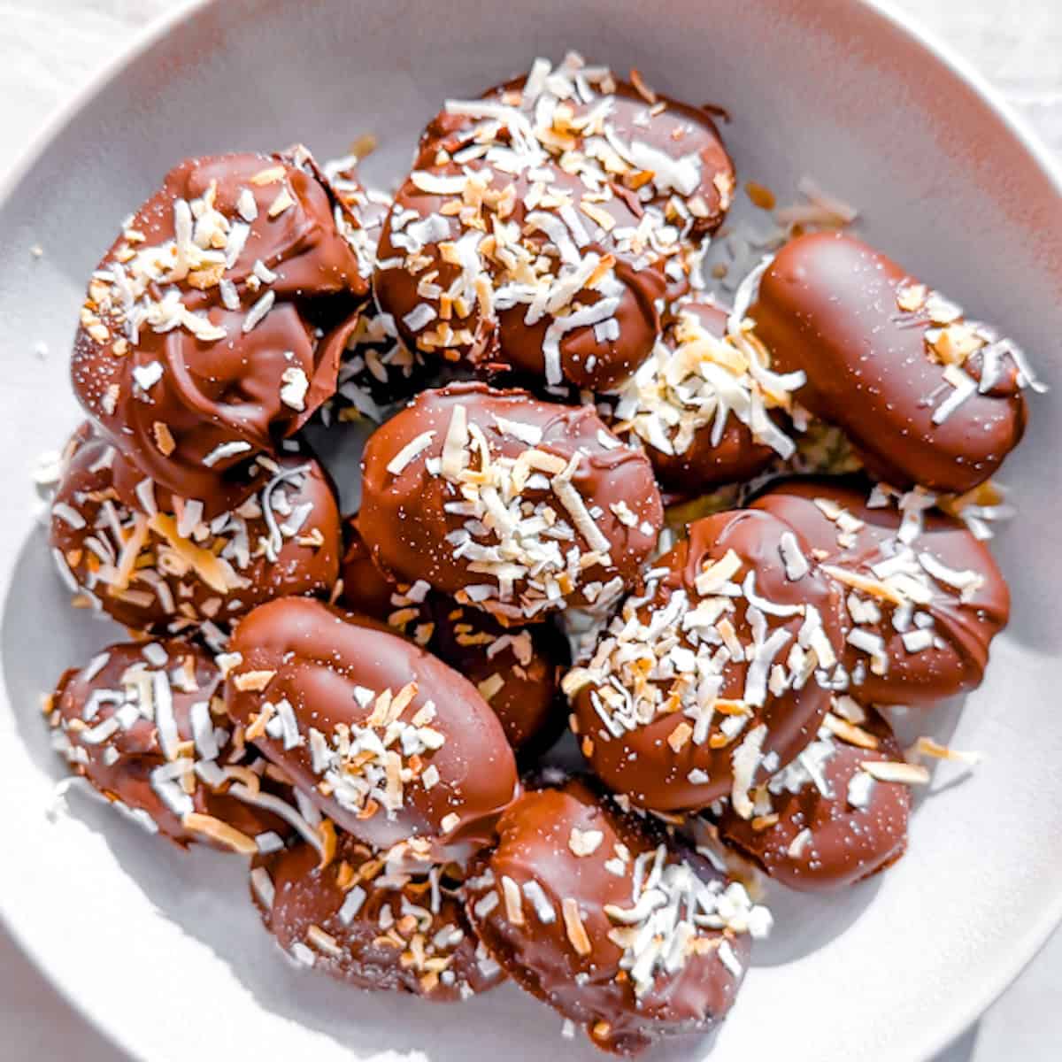 dates covered in chocolate and coconut
