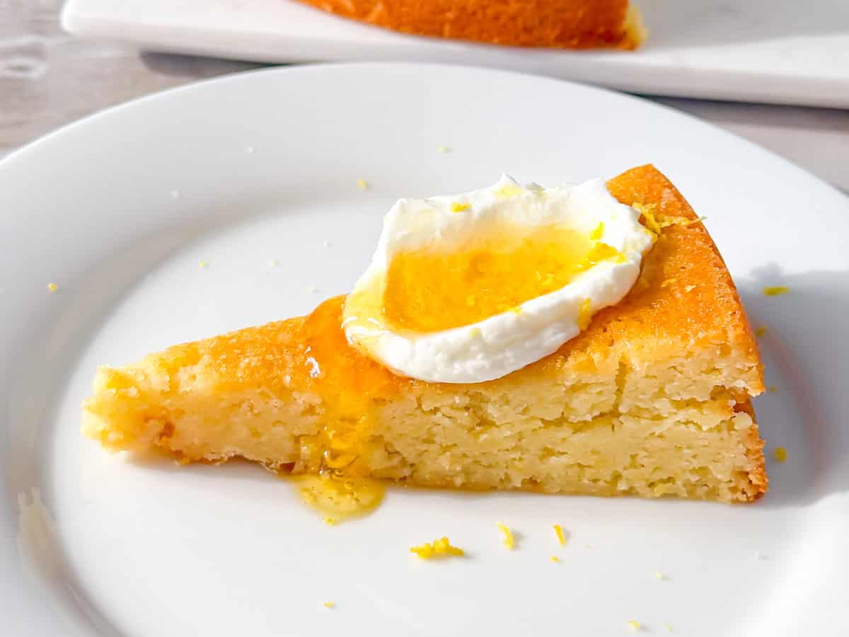 Finished lemon olive oil cake on a white plate.