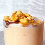 Peanut butter smoothie topped with peanuts.