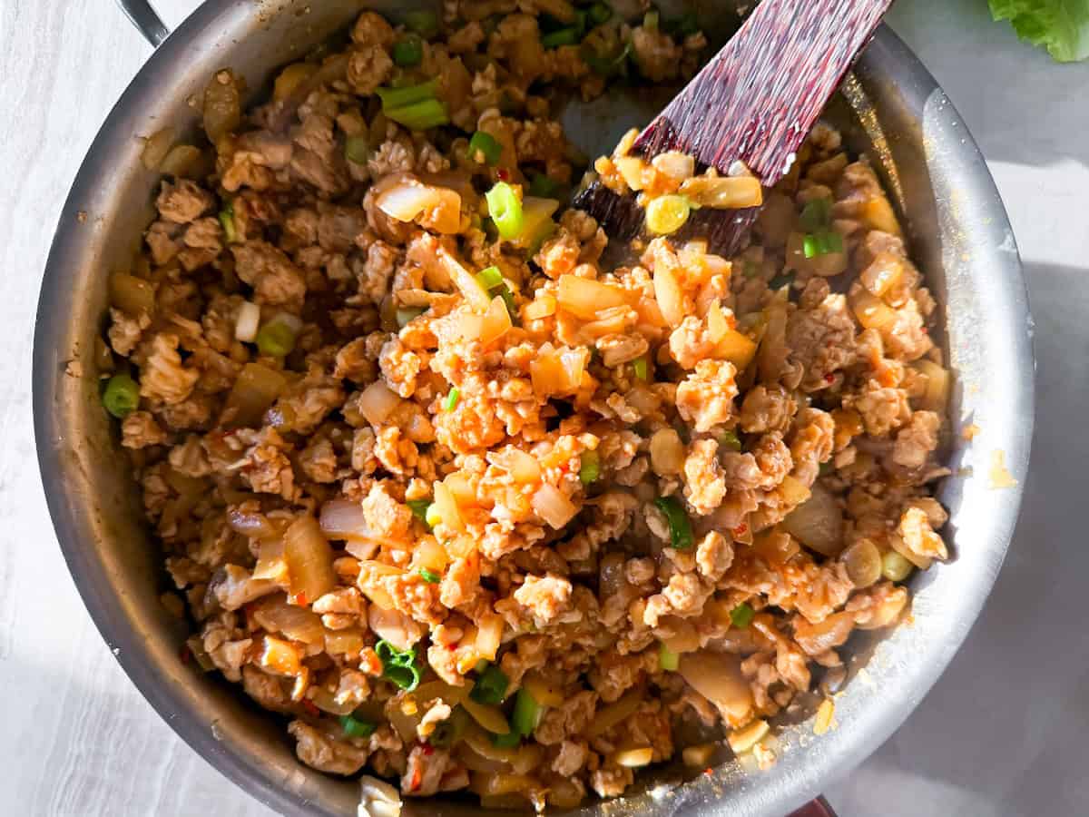 Cooked ground chicken and ingredients in a pan.