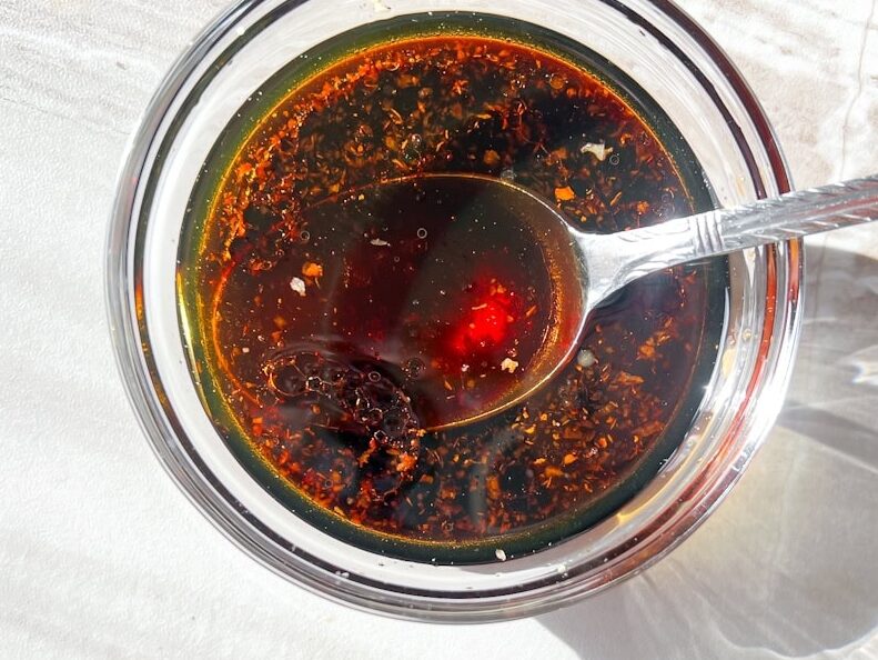 soy sauce, ginger, garlic, sesame oil, sauce in a clear bowl.