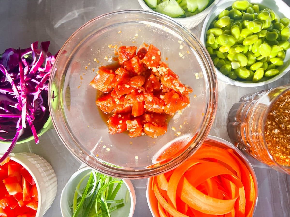poke bowl ingredients in clear bowls.