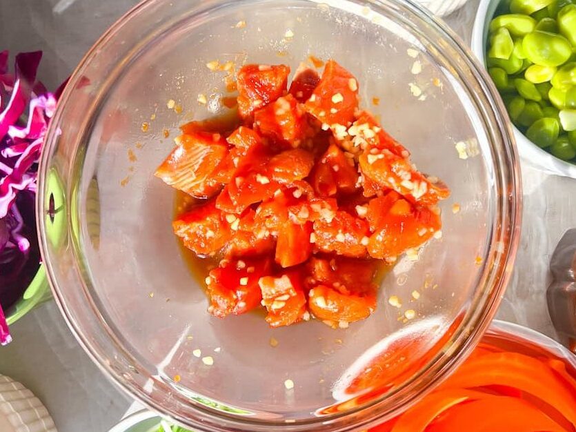 salmon with marinade in a bowl.